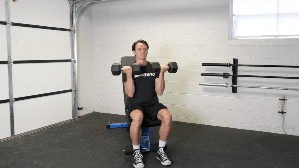 BarBend's Jake Herod performing the arnold press exercise.