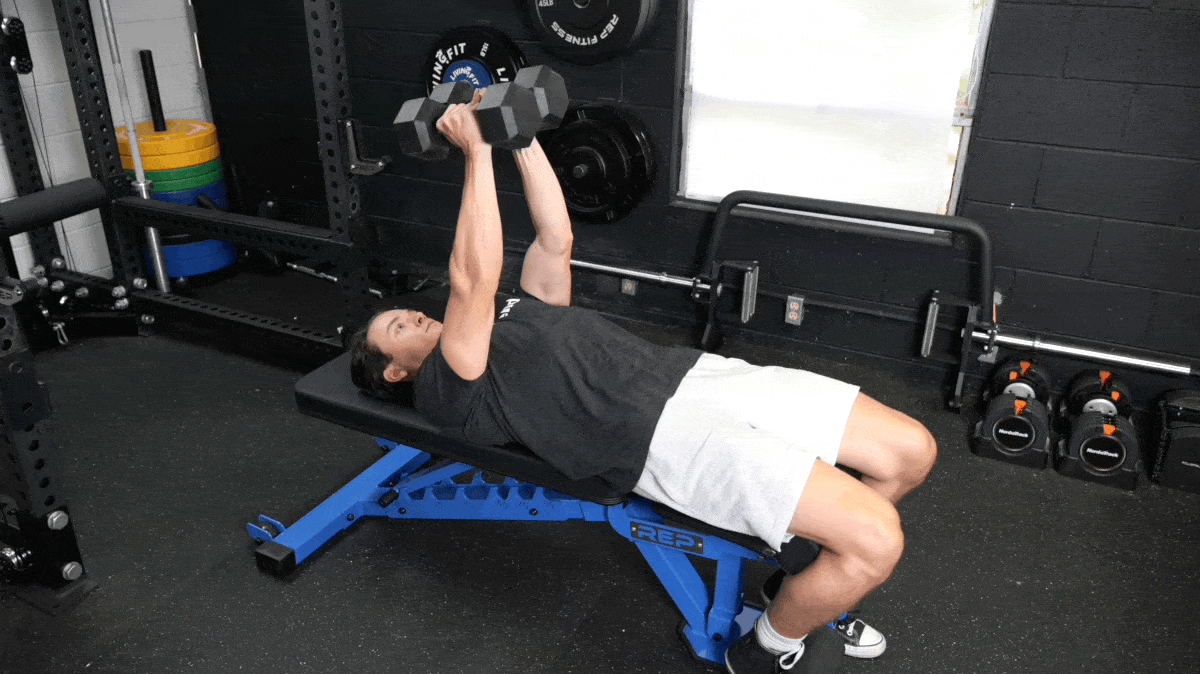 BarBend's Jake Herod performing the dumbbell flye exercise.