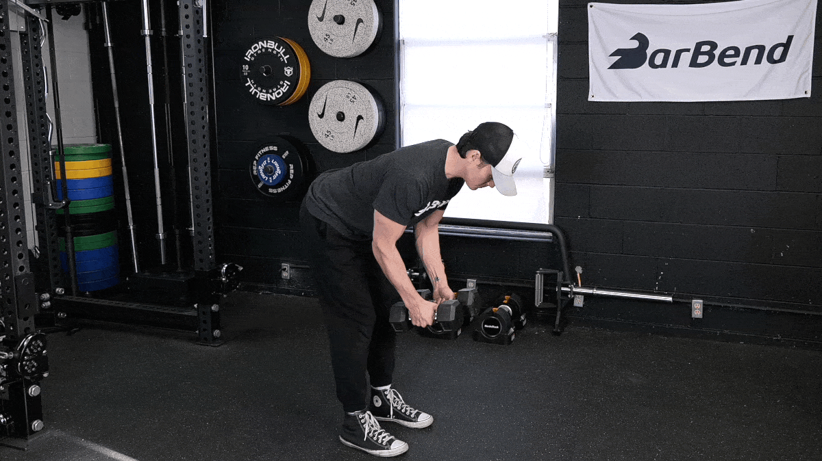 BarBend's Jake Herod performing the dumbbell reverse flye exercise.