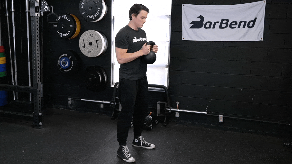 A person performing the goblet squat exercise.